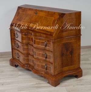 Reproduction of a baroque style chest of drawers with flap shaped in national walnut