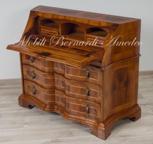 Reproduction of a baroque style chest of drawers with flap shaped in national walnut