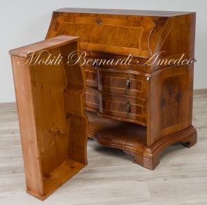 Reproduction of a baroque style chest of drawers with flap shaped in national walnut