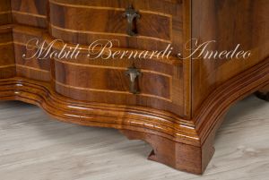 Reproduction of a baroque style chest of drawers with flap shaped in national walnut