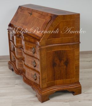 Reproduction of a baroque style chest of drawers with flap shaped in national walnut