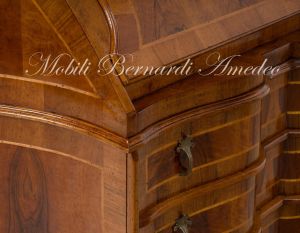 Reproduction of a baroque style chest of drawers with flap shaped in national walnut