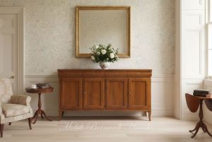 Reproduction of a Louis Philippe style wooden sideboard with a length of 200 cm inserted in an English country style setting