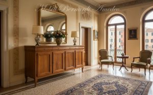 Reproduction of a 200 cm long Louis Philippe style wooden sideboard inserted in a classic Venetian house