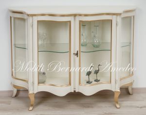 Low shaped showcase with 2 colored wooden doors