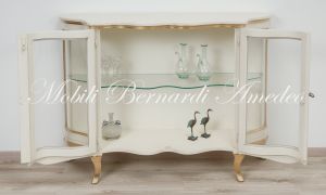 Low shaped showcase with 2 colored wooden doors