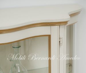Low shaped showcase with 2 colored wooden doors