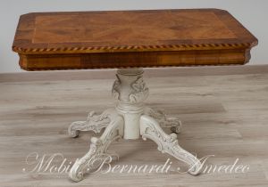 Coffee table with walnut top and turned central leg with white carved legs