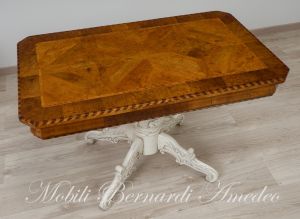 Coffee table with walnut top and turned central leg with white carved legs