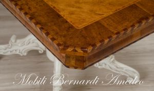 Coffee table with walnut top and turned central leg with white carved legs