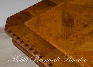 Coffee table with walnut top and turned central leg with white carved legs
