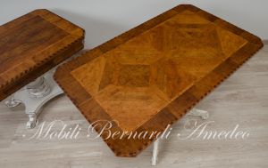 Coffee table with walnut top and turned central leg with white carved legs