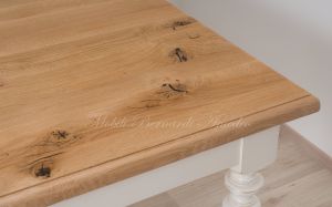 Solid wood table with turned legs and natural oak top with hand-planed knots