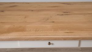 Solid wood table with turned legs and natural oak top with hand-planed knots