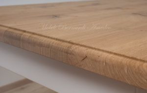 Solid wood table with turned legs and natural oak top with hand-planed knots