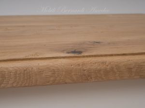 Solid wood table with turned legs and natural oak top with hand-planed knots