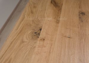 Solid wood table with turned legs and natural oak top with hand-planed knots