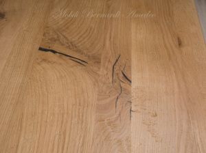Solid wood table with turned legs and natural oak top with hand-planed knots