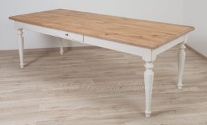 Country style wooden table with top in planed solid oak with knots and antique white turned legs
