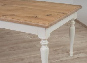 Country style wooden table with top in planed solid oak with knots and antique white turned legs