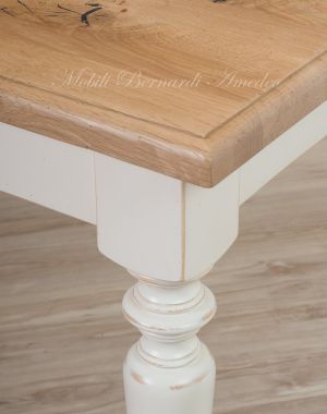 Country style wooden table with top in planed solid oak with knots and antique white turned legs