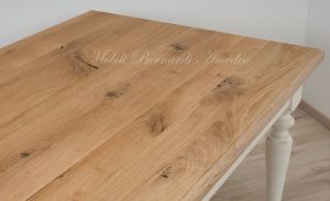 Country style wooden table with top in planed solid oak with knots and antique white turned legs