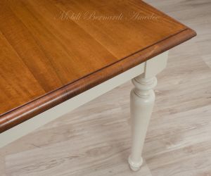 Tavolo massiccio stile country con piano in noce nazionale e gambe tornite colore bianco anticato