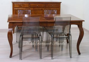 Wooden table with curved legs and barbed top