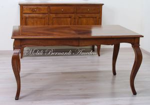 Wooden table with curved legs and barbed top