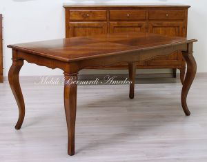 Wooden table with curved legs and barbed top