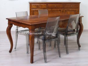Wooden table with curved legs and barbed top