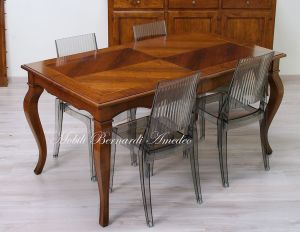 Wooden table with curved legs and barbed top