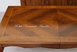 Wooden table with curved legs and barbed top