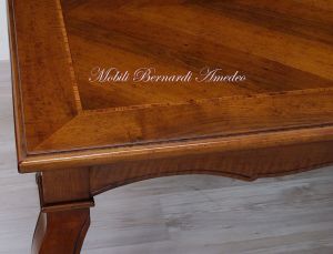 Wooden table with curved legs and barbed top