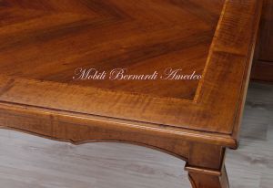 Wooden table with curved legs and barbed top