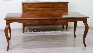 Wooden table with curved legs and barbed top