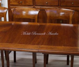 Wooden table with curved legs and barbed top