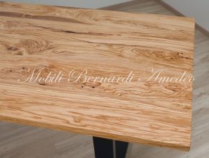 Modern table made with solid olive wood top finished in oil and dark-coloured iron legs