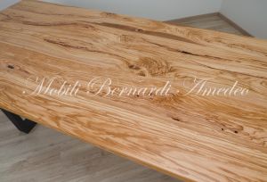 Modern table made with solid olive wood top finished in oil and dark-coloured iron legs