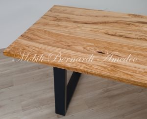 Modern table made with solid olive wood top finished in oil and dark-coloured iron legs