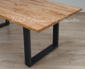 Modern table made with solid olive wood top finished in oil and dark-coloured iron legs
