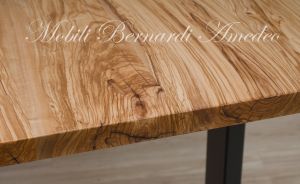 Modern table made with solid olive wood top finished in oil and dark-coloured iron legs