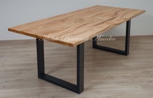 Modern table made with solid olive wood top finished in oil and dark-coloured iron legs