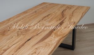 Modern table made with solid olive wood top finished in oil and dark-coloured iron legs