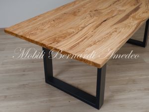 Modern table made with solid olive wood top finished in oil and dark-coloured iron legs